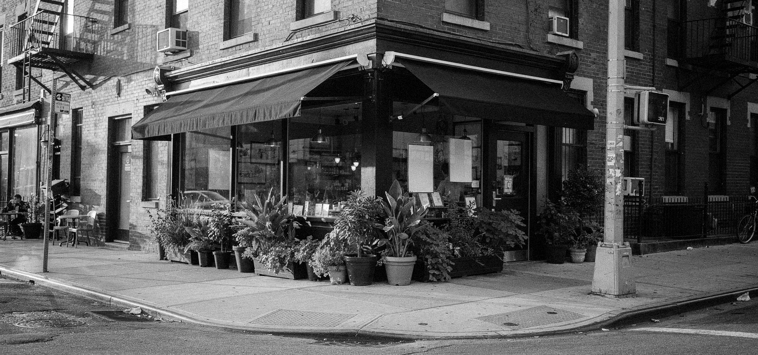 A welcoming corner cafe in the Lower East Side, street-level neighborhood reporting.